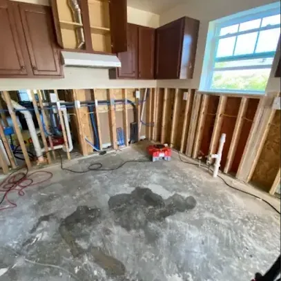 A kitchen stripped to the studs after the wet drywall came out for drying
