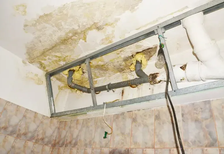 A sagging ceiling with water stains from a leak overhead
